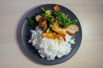 Stir fried crispy pork belly and broccolini with rice.