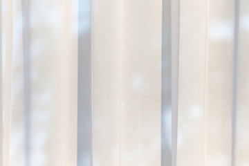 Bright morning or evening sun in the window through the curtains