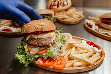 burger with vegetables and french fries