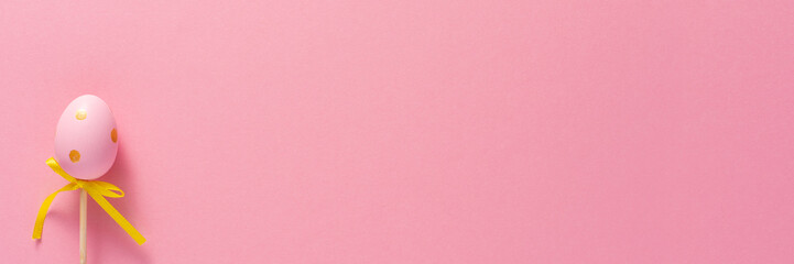 Decorative decoration in the form of Easter eggs on a pink background. Copy space. Easter holiday concept. Banner.