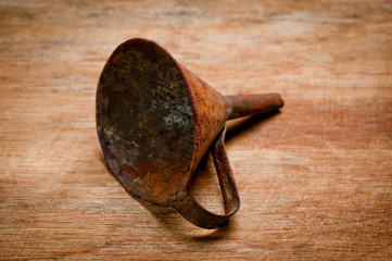 Old vintage metal funnel for filling liquid of the last century extracted from a chest in the...