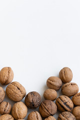 Whole raw walnuts on white background, healthy eating ingredients, vegan and vegetarian food, space for text