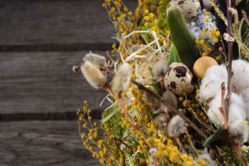 Wreath of dried twigs and flowers on a wooden background. Natural decoration. Celebration concept. Easter wreath. Willow round frame.