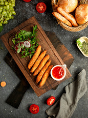 chicken nuggets with a sauce on a wooden board