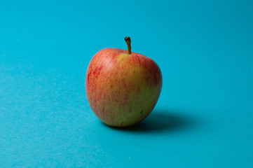 Apple on a blue background. Healthy eating, calorie count and weight loss concept