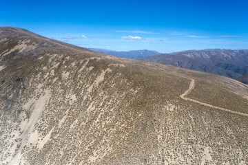 dirt road on edge of barren ridge at Diadem Range, near Quailburn, New Zealand