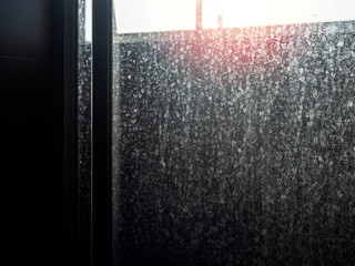 Dusty and dirty glass door. Water stain on sliding door in bathroom.
