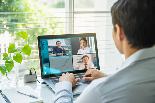 Businessman talking to his colleagues about plan in video conference. Multiethnic business team using laptop for a online meeting in video call.