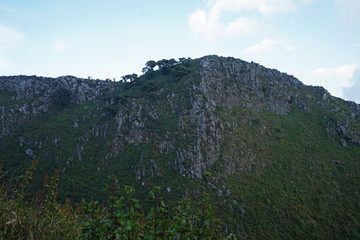 Natural landscape of green mountain range with cloudy blue sky