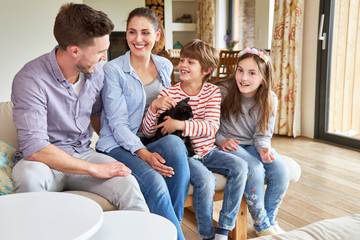 Happy family with cat and two kids