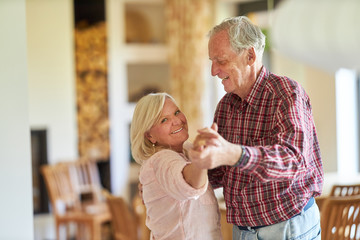 Happy seniors couple while dancing