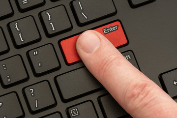 Finger pressing the ENTER button