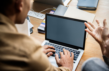 People working on a laptop in a meeting