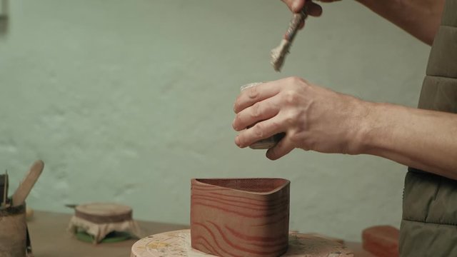 Ceramist work in the workshop.