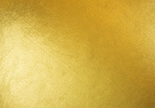 Gold texture background with yellow luxury shiny shine glitter sparkle of bright light reflection on golden surface