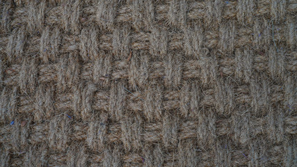 Texture of weaving made of natural brown rope. fleecy geometric texture. way of weaving threads