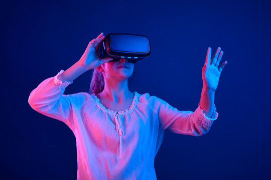 Girl in glasses of vertual reality on a colored background.