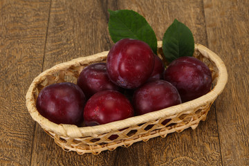 Plum heap in the wooden basket