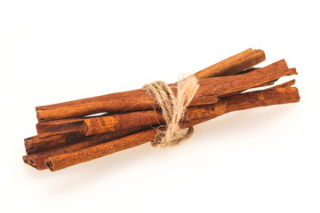 Cinnamon sticks heap isolated on white
