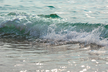 Sea tide splashes, turbulent clear water closeup