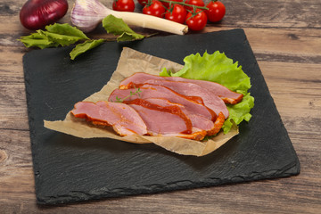 Sliced smoked duck breast served salad
