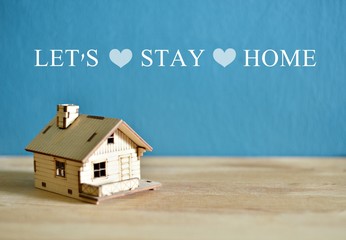 Social media awareness campaign and coronavirus prevention concept with word " LET'S STAY HOME isolated on darkblue background.