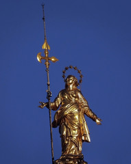 Virgin Mary gold statue in Milan, Italy