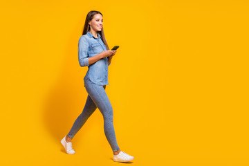 Full size profile side photo lovely charming pretty girl go walk copyspace use smartphone texting her friends meeting wear good look shirt footwear isolated shine bright color background