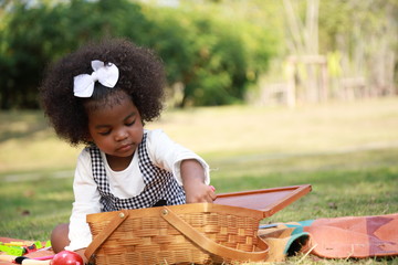 Dark skin kid play toy in the garden