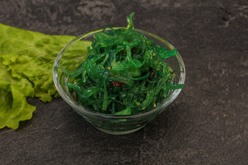 Green Chuka Seaweed Salad Isolated on White Background Top View. Wakame Sea Kelp Salat