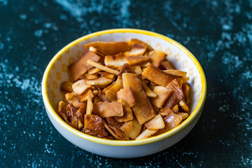 Healthy Organic Roasted Coconut Chips with Caramel Flavor / Caramelized Snacks.