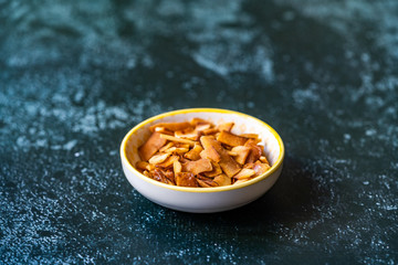 Healthy Organic Roasted Coconut Chips with Caramel Flavor / Caramelized Snacks.