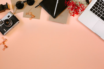 Stylish flat lay designer workplace with film camera, laptop, leather notebook, clips and pen. Flat...