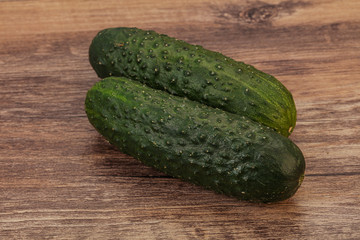 Green fresh cucumbers over background