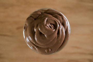 Iced Dalgona Cocoa / Chocolate, a trendy korean style of creamy whipped cocoa on fresh milk, on wooden background. Top view