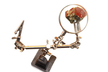 precision scientific magnifying tool with tweezers, piece of magnified pyrite,