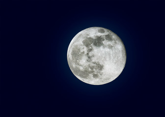 Naklejka na ściany i meble Full moon over dark black sky at night