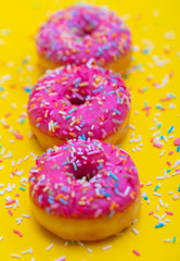 pink donuts with colorful sugar sprinkles 