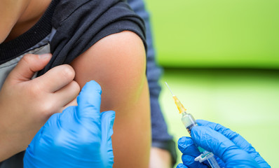Vaccination procedure. Injection in to hand. Close-up