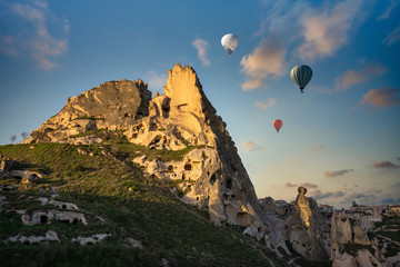 Uchisar Castle and the town is a sandstone mountain filled with tunnels and windows. In the morning, tourists come to see the balloon in Cappadocia, Turkey.