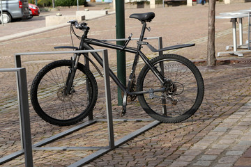 Fototapeta na wymiar bike is fastened to rack of street fence