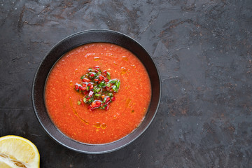 Tomato soup. Dark background. Top view. Flat lay