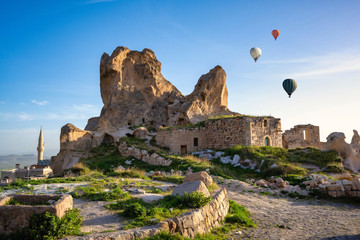 Uchisar Castle and Balloon and the town is a sandstone mountain filled with tunnels and windows. In the morning, tourists come to see the balloon in Cappadocia, Turkey.