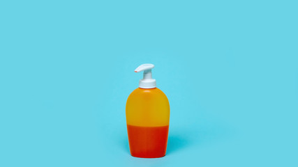 A bottle with an antiseptic, detergent, soap on a blue background. Hand disinfection. Disease Prevention Stay at home while in quarantine. coronavirus protection. Close-up.