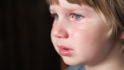 The little boy is crying and very upset.   The boy is crying from resentment and grief, the tears of a child. 