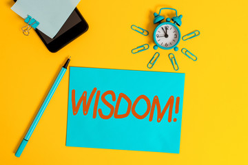 Text sign showing Wisdom. Business photo showcasing quality having experience knowledge and good judgement something Smartphone clock clips paper sheet notepad ballpoint colored background