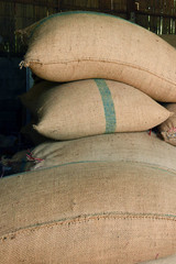  Stack of bags with coffee beans at warehouse