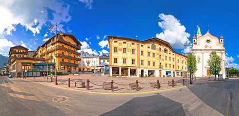 Fototapeta na wymiar Cortina d' Ampezzo main square architecture and church panoramic view