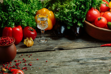Ripe fresh vegetables on a wooden table. Background of vegetables with an empty space in the middle.