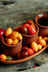 Ripe fresh vegetables on a wooden table. Background of vegetables with an empty space in the middle.